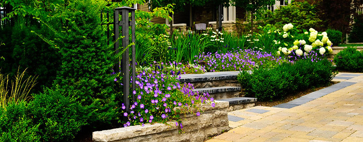 landscaped garden and stone paved driveway s